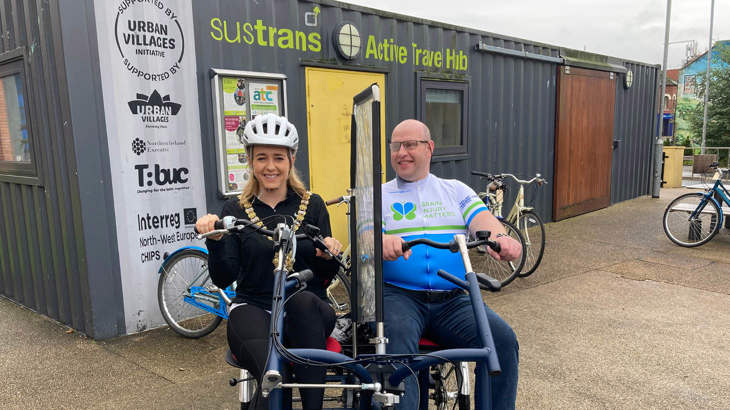 Lord Mayor Kate Nicholl and Graham Hill on the side by side bike at CS Lewis Square, Belfast