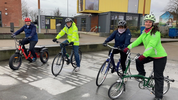 A group of people on bikes take part in cycle training at CS Lewis Square.
