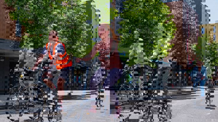 People on bikes cycling in a London street