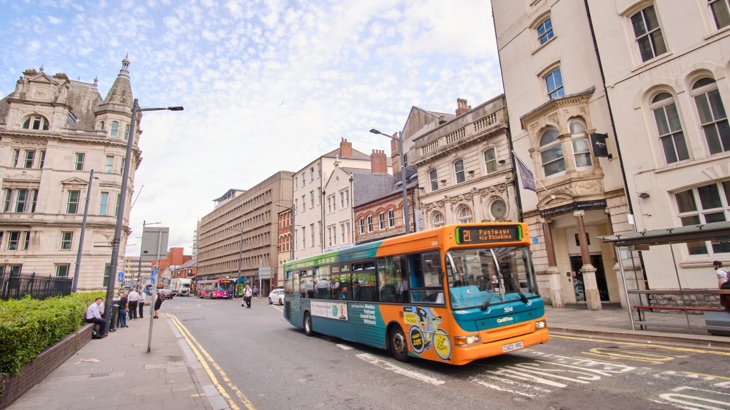 Public transport bus driving through Cardiff city centre