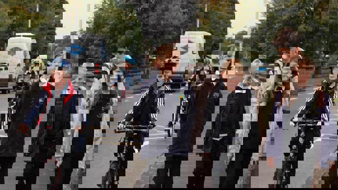 Children in school uniform walking and cycling 