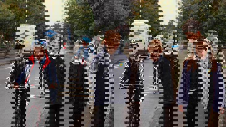 Children in school uniform walking and cycling 