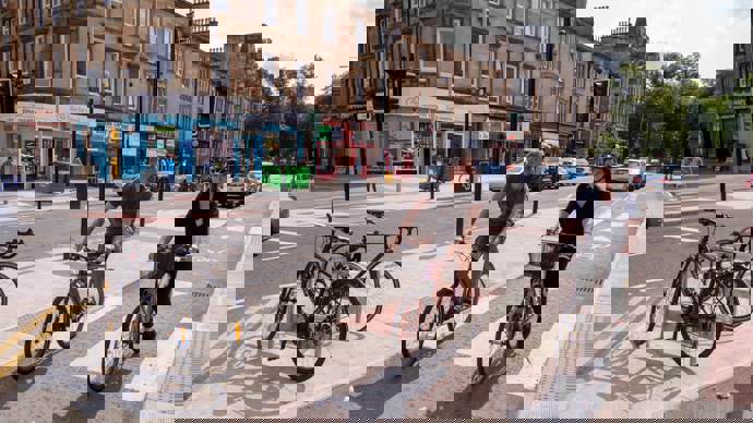 Two cyclists in a protected cycle lane