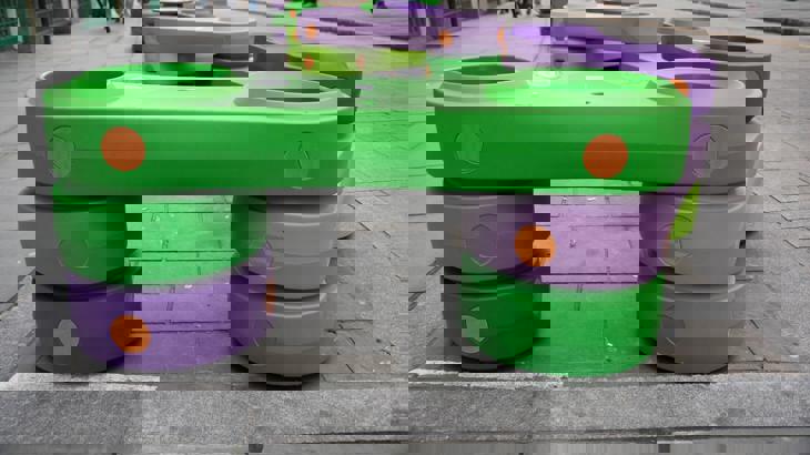 Green and orange plastic blocks on city street