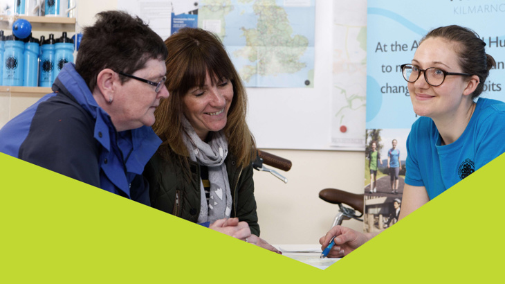 A group of three women happily chatting in Walk Wheel Cycle Trust's  Active Travel Hub in Kilmarnock