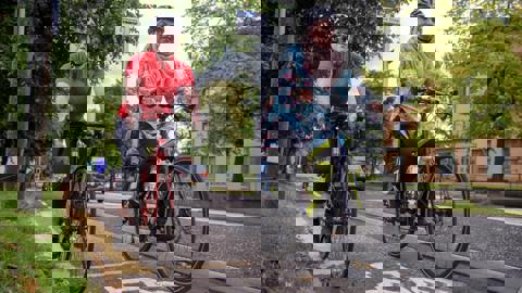 Two women cycling together on a segregated cycle lane