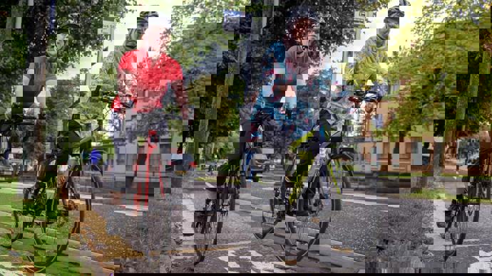 Two women cycling together on a segregated cycle lane
