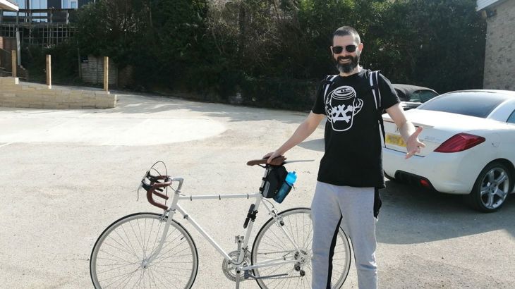 person holding bike in paved area