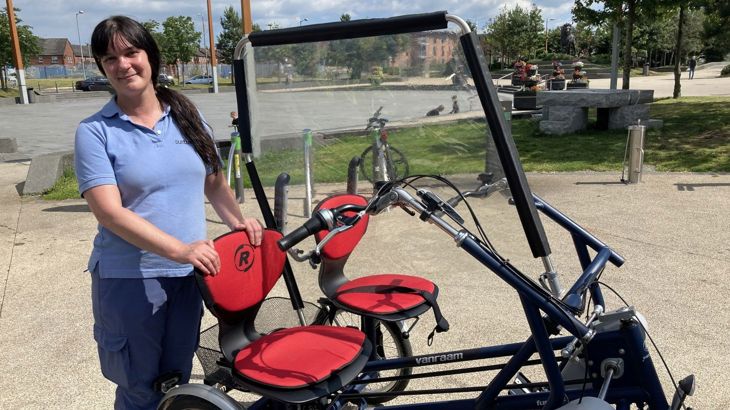 Female instructor with side-by-side adapted bike