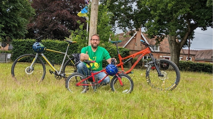 Walk Wheel Cycle Trust Bike It Officer in green space with bicycles