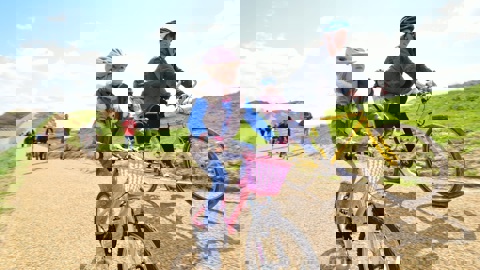 Mother and daughter cycling along a traffic-free National Cycle Network path