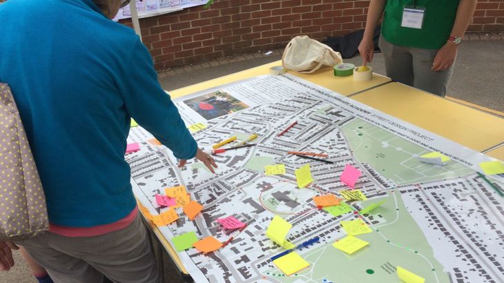 looking at map discussing light touch interventions for traffic calming outside school