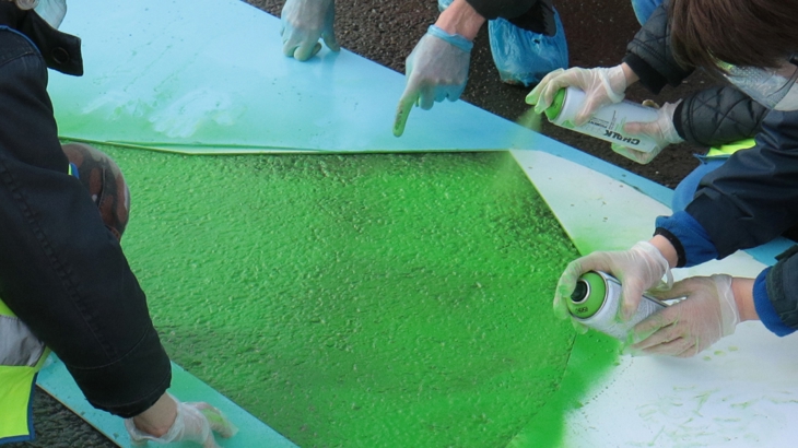 trialling a traffic calming dragon design by painting it on the road outside school