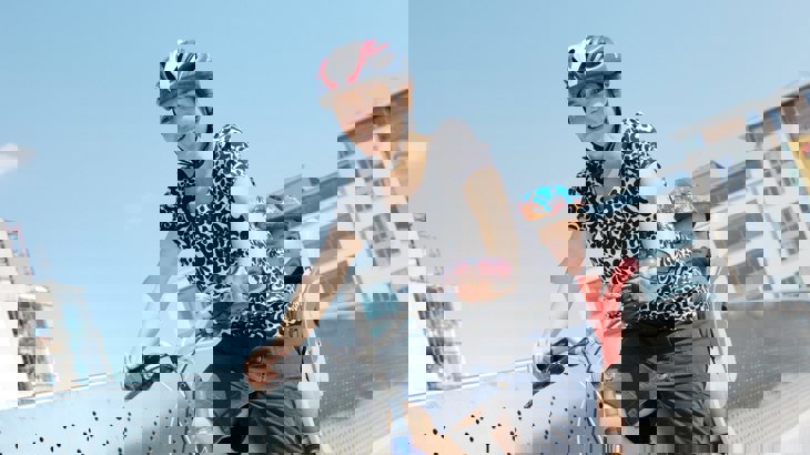 Mum cycling with child in bike seat behind her