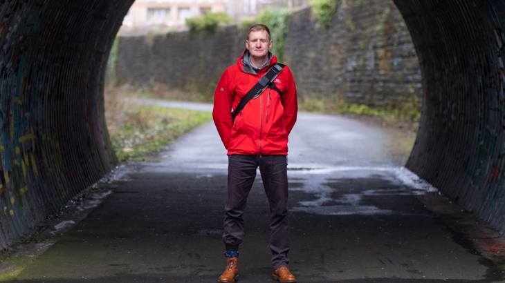Jon Jewitt is pictured standing in front of a tunnel on National Cycle Network 7
