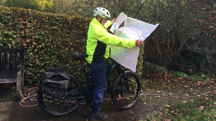 Norman Feakins, an e-bike rider in his 70s, looking at his map of the National Cycle Network.