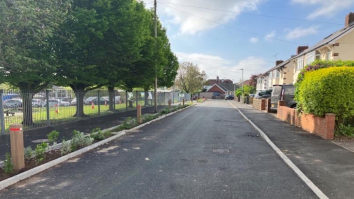A road outside Fairfield Primary School, with traffic calming measures and a rain garden incorporated into the new physical layout.