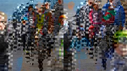 People cycling, walking and scooting to school