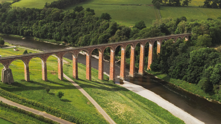 Aerial view of Leaderfoot Viaduct crossing a river.