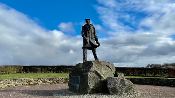 The monument to Sir David Stirling, founder of the SAS, stands in amongst green landscape.