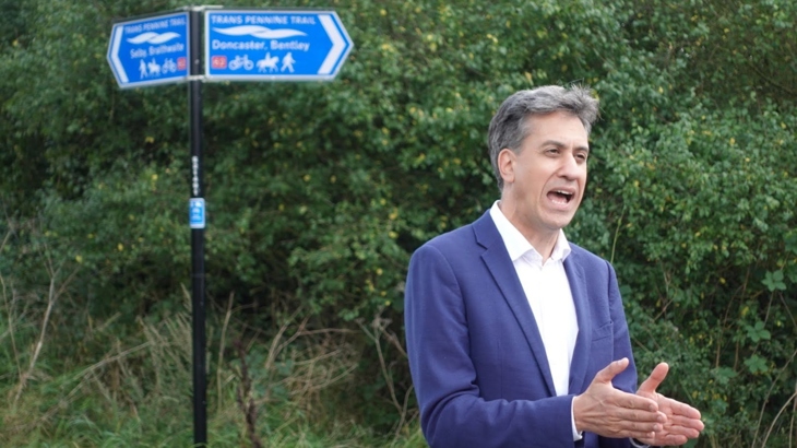 Ed Miliband visits Doncaster section of the National Cycle Network and speaks to camera, with a signpost behind him