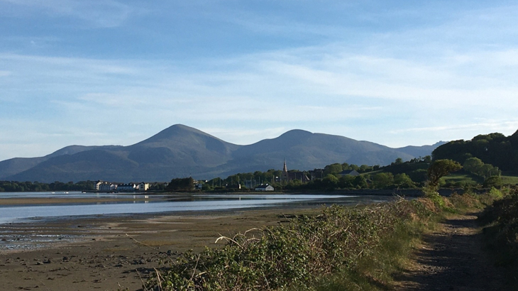 A bay in Scotland on a clear day with a mountainous backdrop