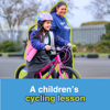 Virtual Gift A Children's Cycling Lesson: Image shows a young girl joyfully taking her first pedals in a playground, with a Walk Wheel Cycle Trust Schools Officer