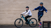 A woman leading a cycling session and a teenage girl on a bike