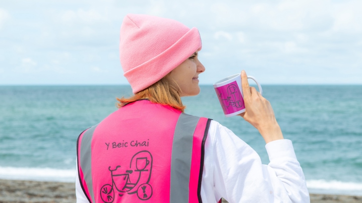 Sally looking out over the Irish sea whilst drinking tea.