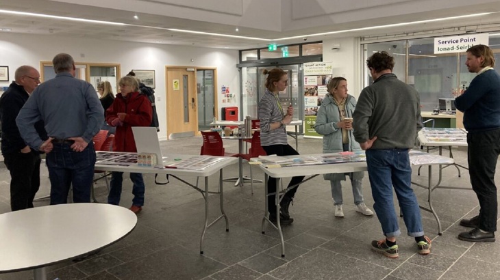 Members of the community speak with project delivery officers at an engagement event in Wick