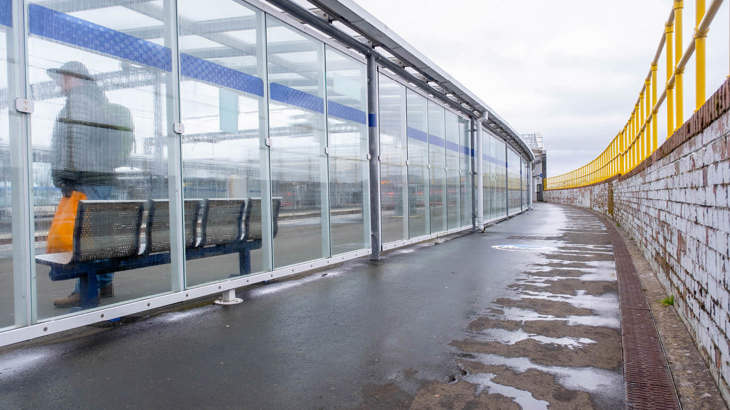 A shared-use, segregated path at Gourock Station showing train platforms to the left and the Clyde to the right