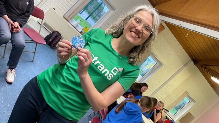 Walk Wheel Cycle Trust in Wales Director Christine Boston holding the first Active Adventures badge at the launch event with the 2nd Newtown Guides.
