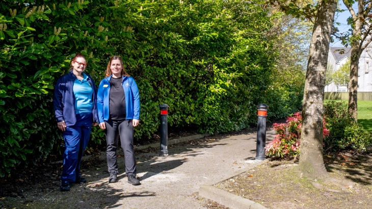 Angela and Hannah, physiotherapists at Leverndale Hospital, stand beside an adapted barrier on National Cycle Network Route 7.