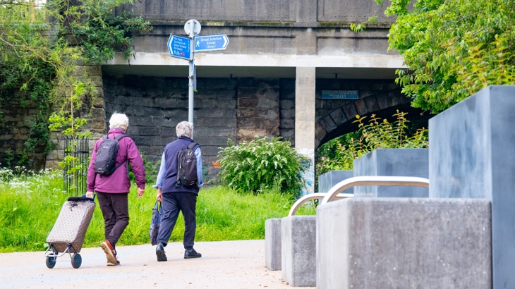 Two people walk through the newly opened Coalie Park on National Cycle Network Route 75 in Leith.