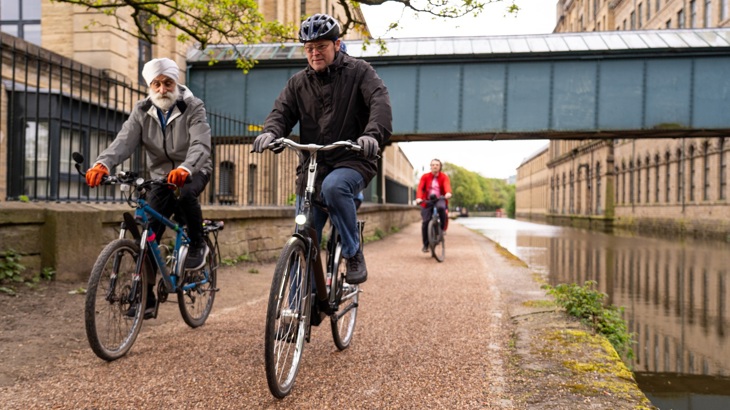 two men at front of group ride on the towpath