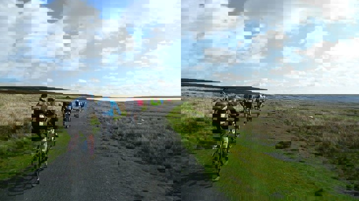 People cycling along a traffic-free National Cycle Network route in Land's End.