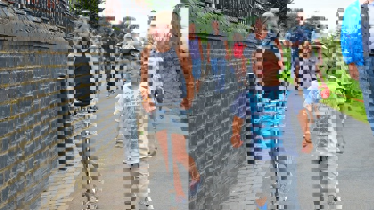 children and families walking and scooting on pavement