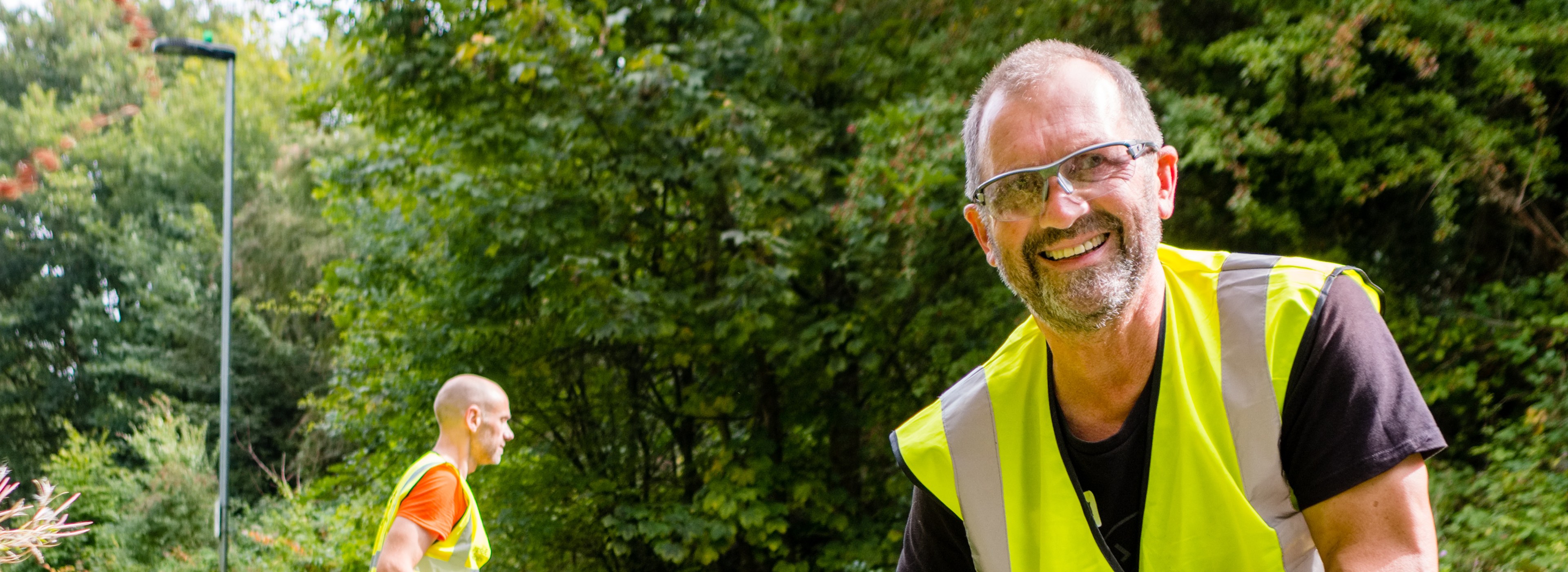 Man smiling at the camera whilst volunteering on the NCN