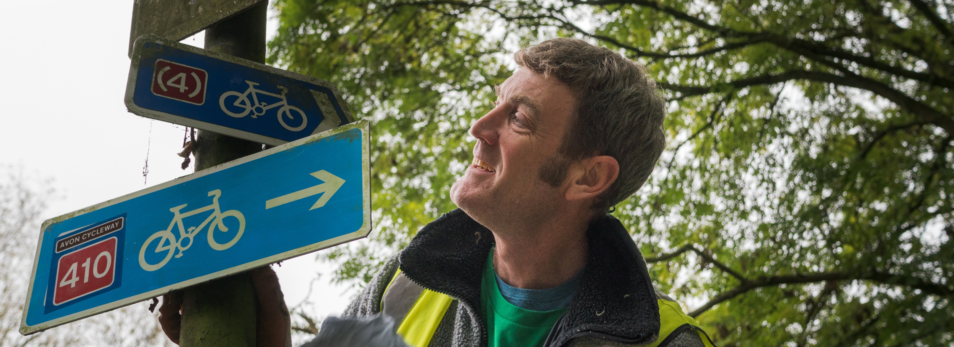 Volunteer cleaning a National Cycle Network sign