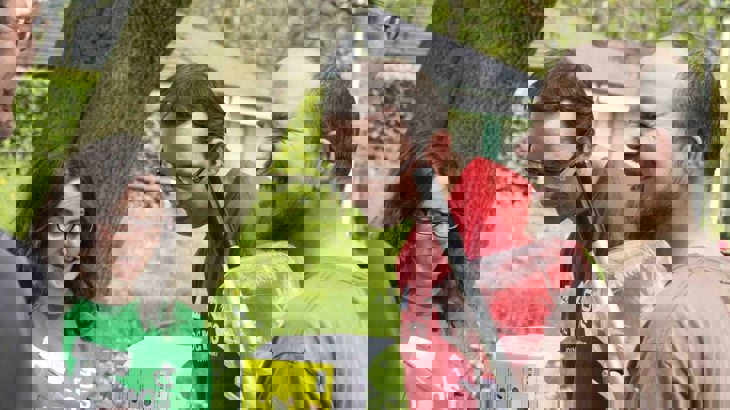 Group of volunteers looking at wildlife id guides and chatting