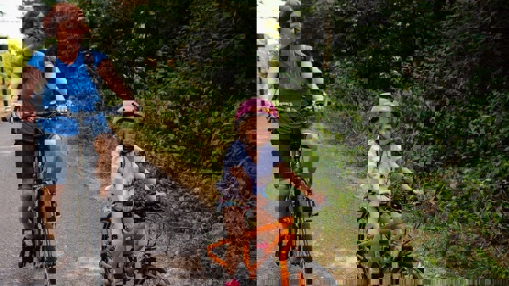 Mum riding bike with daughter on traffic-free path