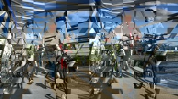 Family walking with bicycles over a bridge