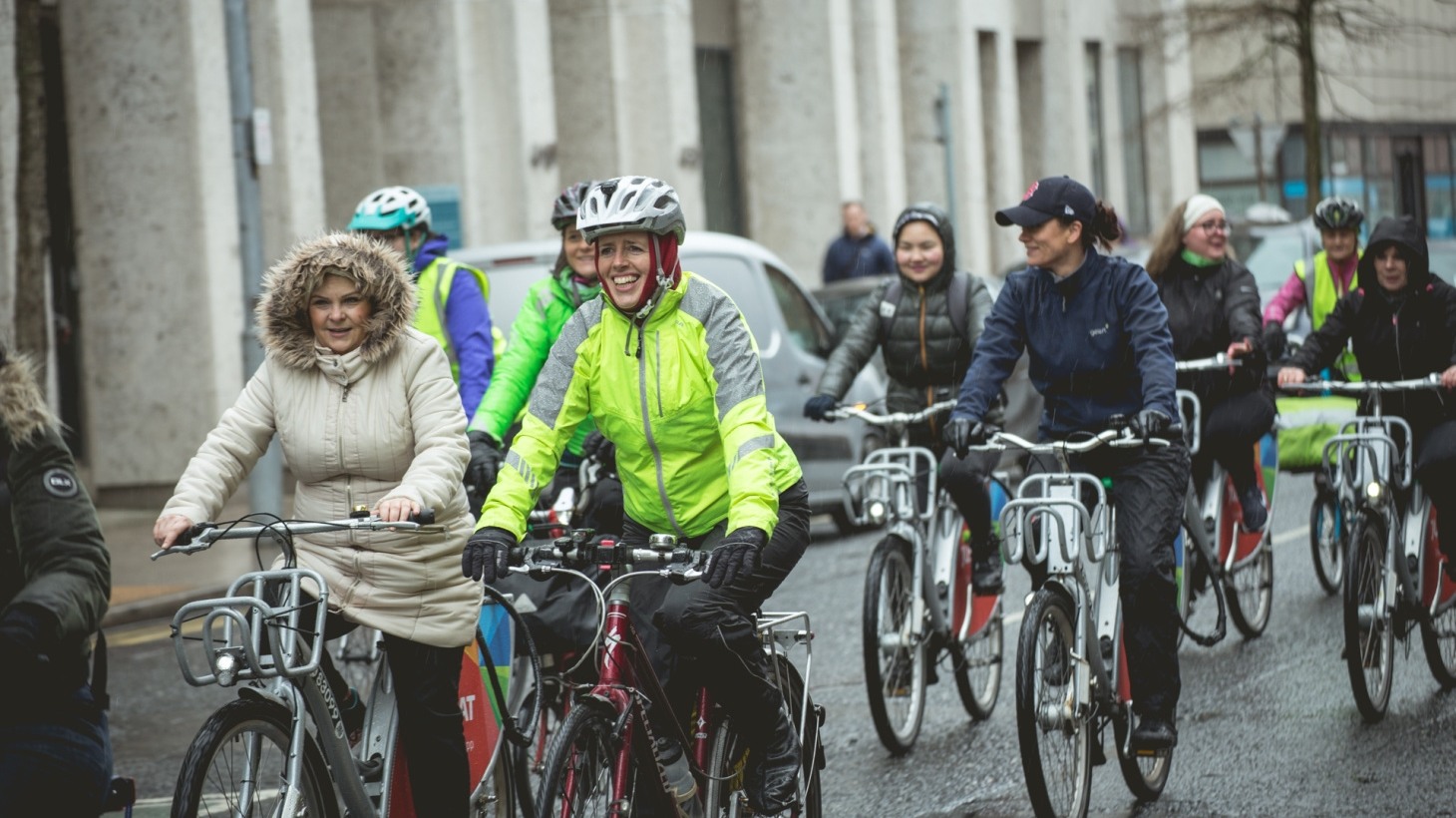 Group of people cycling along road in NI