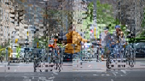 A Woman Standing At Some Traffic Lights In Edinburgh