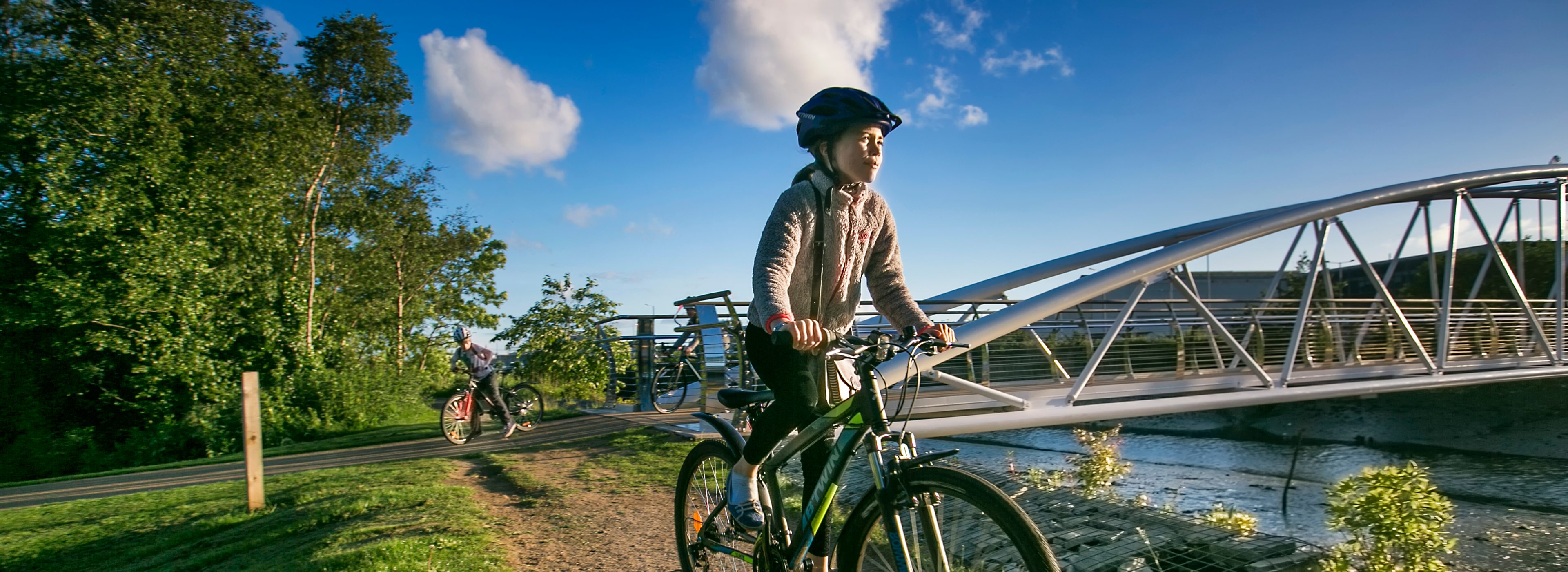 Child cycling along NCN next to bridge