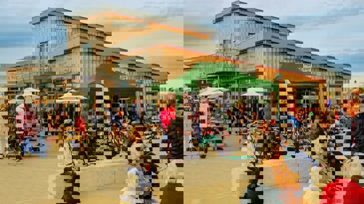 Cycle friendly cafe with man ordering a coffee at counter