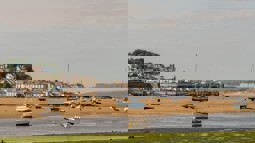 Yachts and boats in harbour of Devon town with the tide out