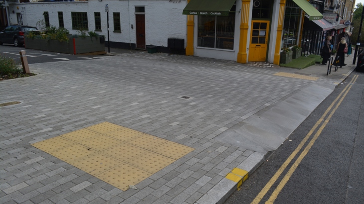 The pavement outside a cafe near the school has been widened