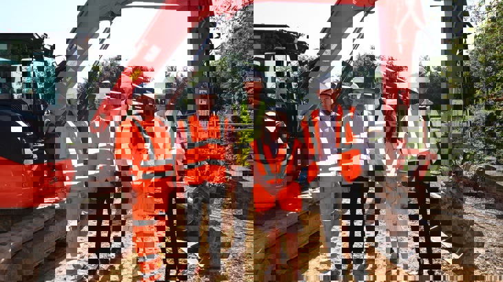 Councillors visit the project on Castleford Greenway and stand in front of a digger used in the construction