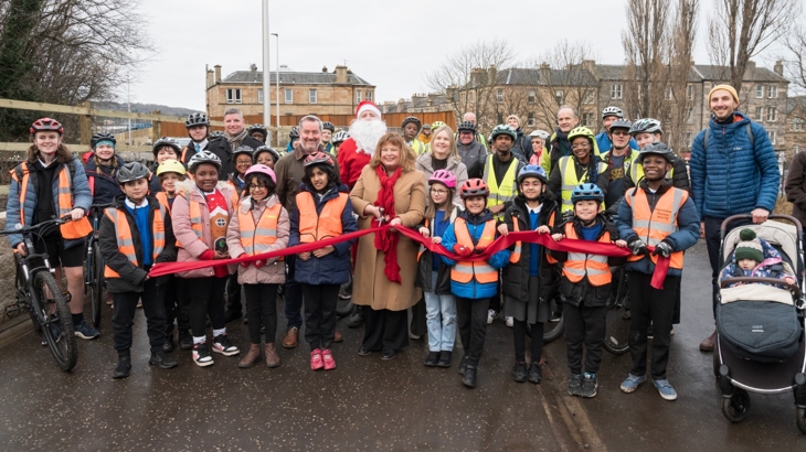 Transport and Environment Convener, Councillor Stephen Jenkinson was joined by Cabinet Secretary for Transport Fiona Hyslop, Scotland Director for Walk Wheel Cycle Trust, Karen McGregor alongside groups of local schoolchildren and representatives of the Dalry community, to cut the red ribbon marking the opening of the Roseburn to Union Canal active travel route.